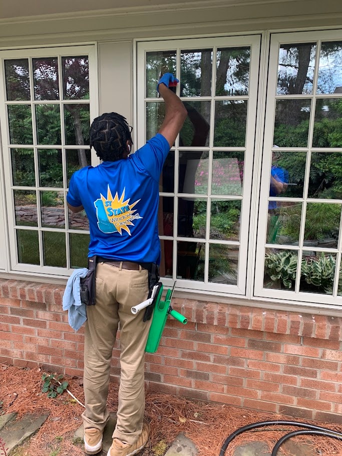 Window cleaning technicians working on brick-home windows